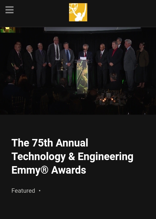 “Rouzbeh Yassini giving speech with LANcity team and Emmy hosts”